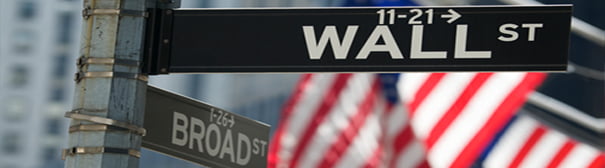 Street signs at the intersection of Broad and Wall Street.