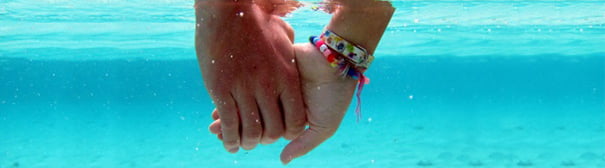 Photo of hands holding underwater