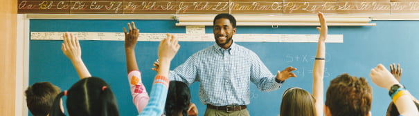 Photo of teacher in front of classroom
